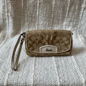Coach natural beige clutch with cream detailing.